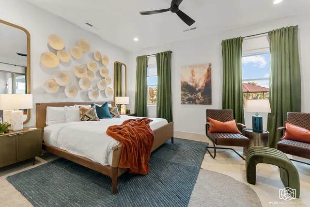 Guest bedroom with green drapery and layered textiles