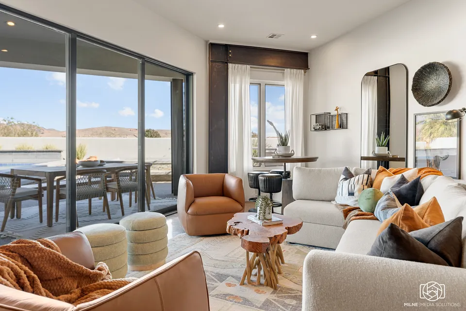 Layered living room overlooking the landscape at the Belmont Avenue vacation home