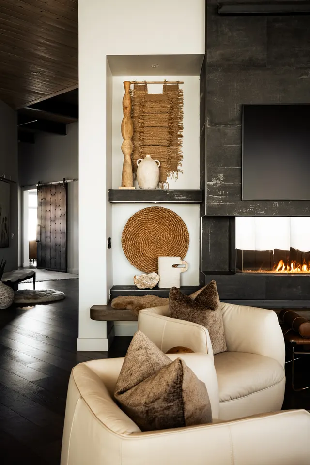 Textured artwork and seating beside the fireplace