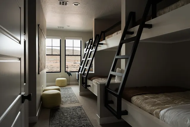 Bunk room with black rails and ladders