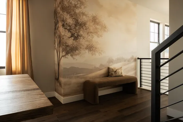Bedroom with a landscape mural and upholstered bench