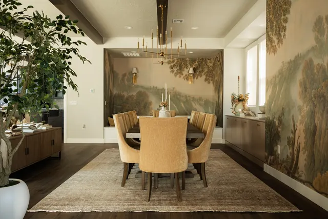 Dining room framed by a landscape mural