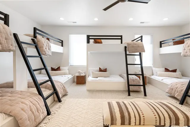 Bunk room with black frames and soft neutral bedding