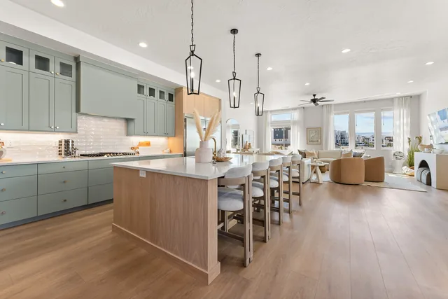 Open kitchen with soft green cabinetry