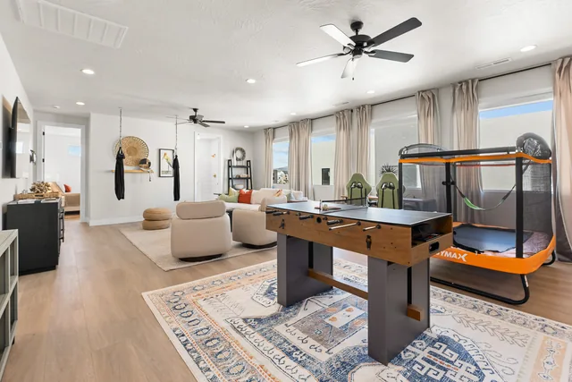 Game room with an enclosed mini trampoline and foosball table